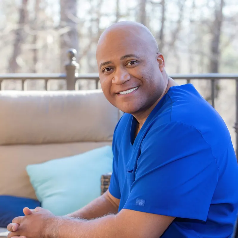 Dr. Cooper in blue scrubs